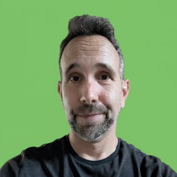 Photograph of Mike Todasco against a green screen